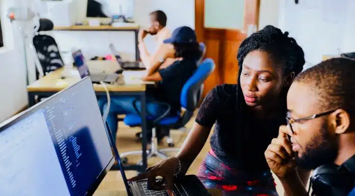 woman and man sitting in front of monitor